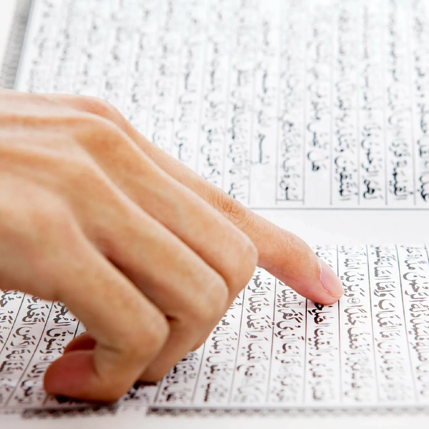 Hand pointing to lines of Arabic text—standard Arabic document translation services