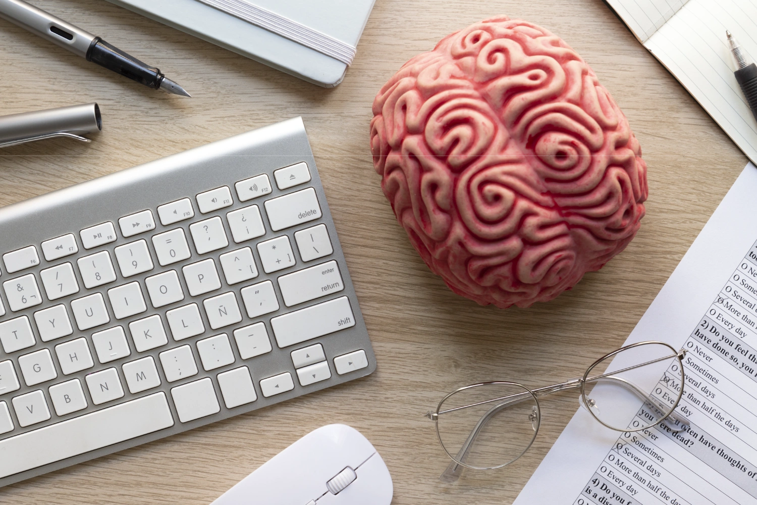 Desktop workspace with a brain model and keyboard, symbolizing translation memory.