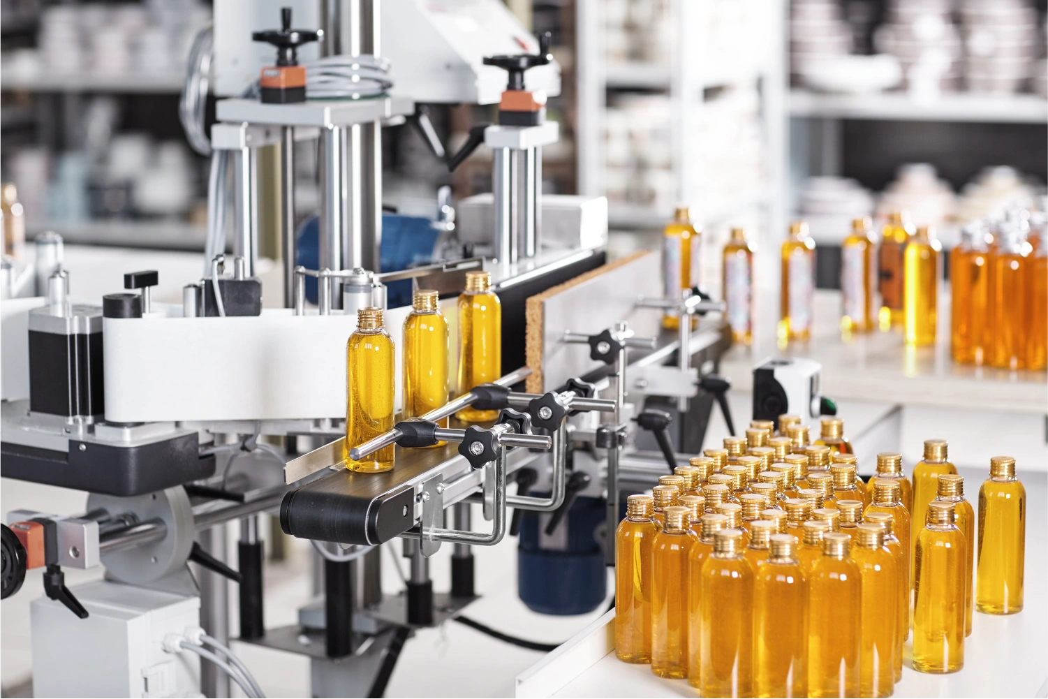 Automated bottling line fills amber liquid into pharmaceutical containers, illustrating manufacturing stage in life sciences industry