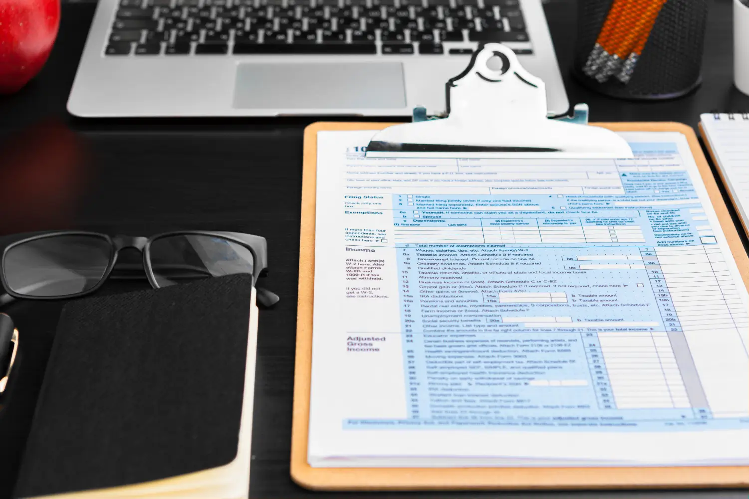 Clipboard with legal form beside laptop—Portuguese document translation services.