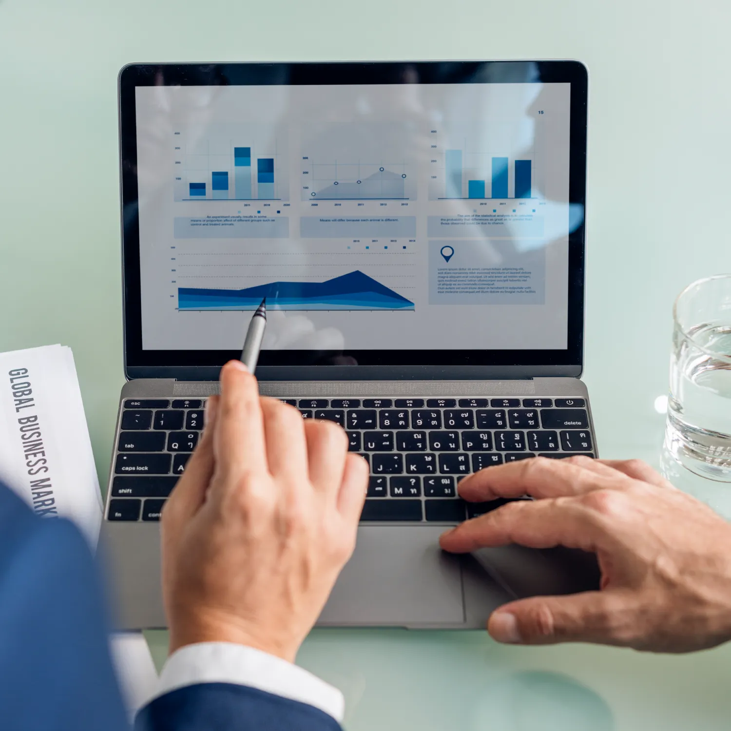 Executive analyzing charts on laptop, pointing at a prompt optimization dashboard for global content and localization performance